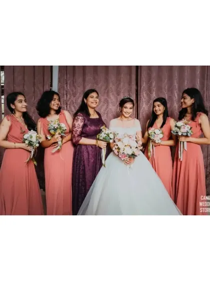 The bride with her bridesmaids, a lovely portrait capturing the friendship and support surrounding her on her wedding day.