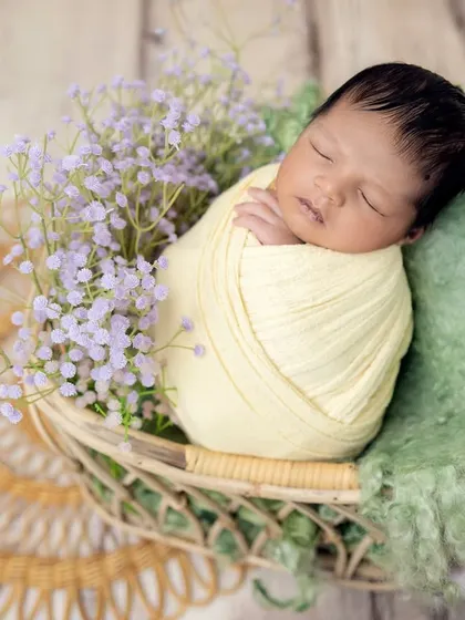 A wider angle of the yellow and lavender setup, showing the wicker basket and the soft green blanket underneath.