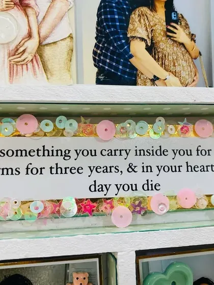 "A baby is something you carry inside you for nine months, in your arms for three years, & in your heart until the day you die." A heartfelt quote within the frame.