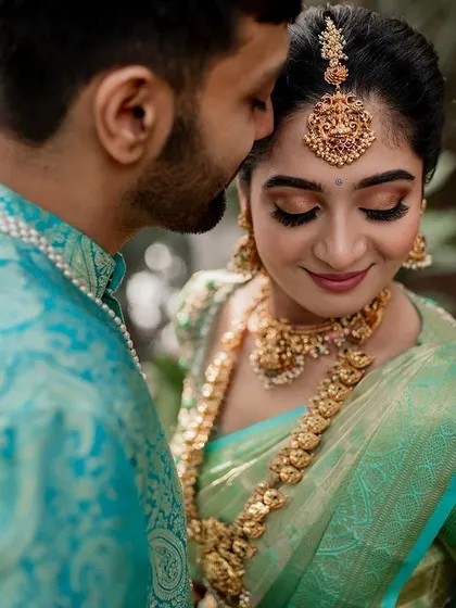A tender moment between the couple, showcasing their beautiful coordinated outfits. Our goal is to capture the subtle emotions and details that make your wedding portraits special.
