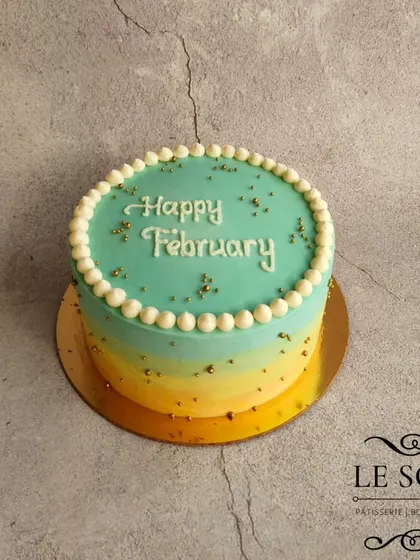 The request was "one part of a rainbow," and this is what we created. This 1 kg vanilla cake features a beautiful blue, yellow, and green ombre buttercream finish.