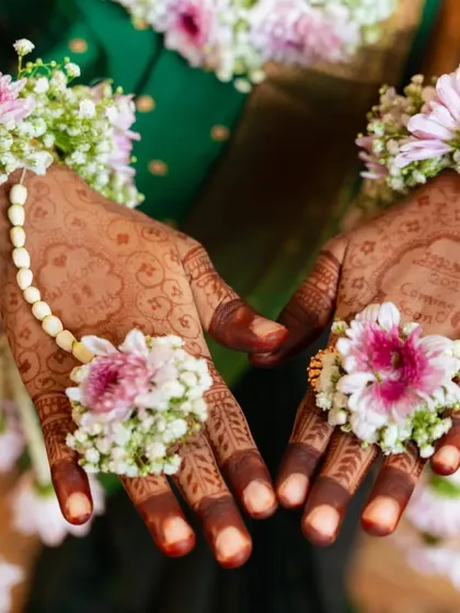 The beautiful, dark stain of a baby shower mehendi, adorned with fresh flower jewelry. This design is filled with blessings for the mom-to-be and her little one.
