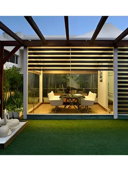 This expansive terrace combines a Zen garden with a modern glass-enclosed seating area. A large Buddha statue serves as the focal point for the open green space, creating a sanctuary for relaxation and reflection.
