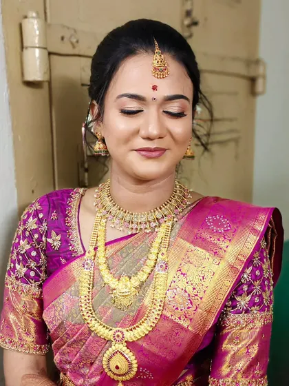A beautiful engagement look with a magenta saree. The makeup is elegant with soft eyes and a matching lip, perfect for the occasion.