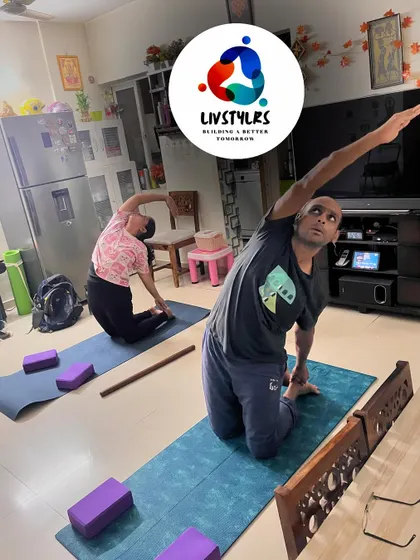 Two clients practice a seated side bend, a great stretch for the spine and obliques.