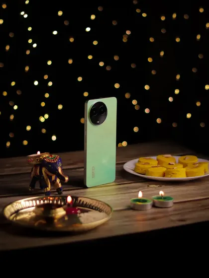 A festive product shot for the realme C67, celebrating Diwali. I arranged the phone with traditional sweets and diyas against a bokeh background to create a warm, celebratory image.
