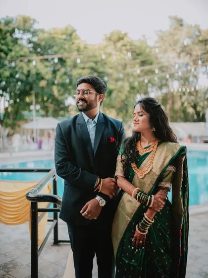 A candid portrait of a couple enjoying a quiet moment by the pool during their engagement event.