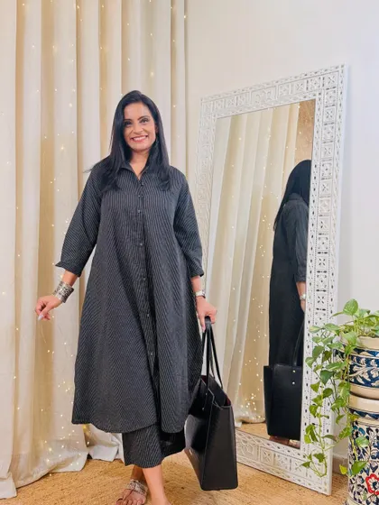 This black striped shirt-style kurta with matching pants is a very smart and professional look. It's comfortable, stylish, and perfect for the office.