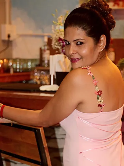 A smiling, over-the-shoulder look in the custom pink dress.