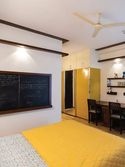 For this kid's room, the client wanted a more grown-up feel. I included a two-seater study table, a bay window for reading, and a large blackboard for creativity, all in a stylish yellow and wood theme.