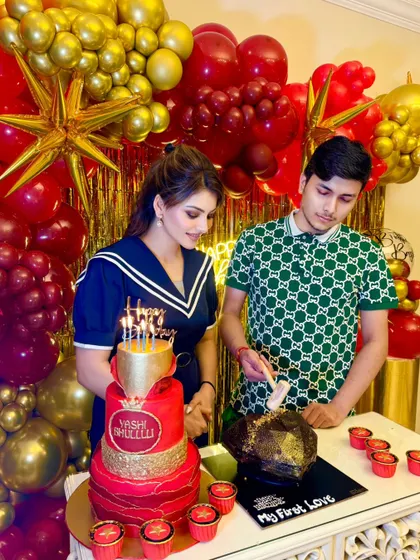 Urvashi Rautela and her brother Yashraj celebrating with his custom red and gold birthday cake and a "smash" chocolate rock dessert.