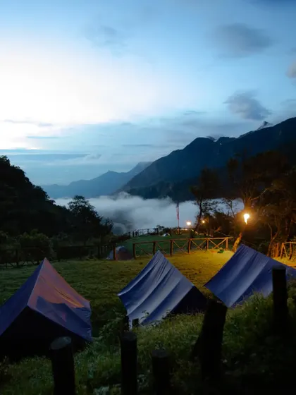 Tents at the Munnar campsite at dusk, with the valley filling up with clouds.