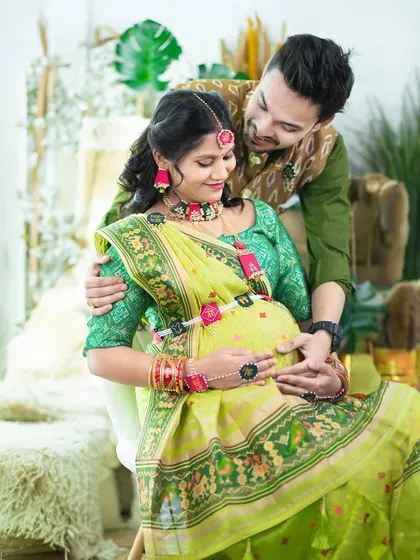 A beautiful traditional portrait of a couple in our boho studio. They are dressed in coordinating green outfits, sharing a tender moment.