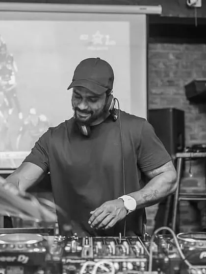 A black and white photo capturing a moment of joy while I'm DJing.