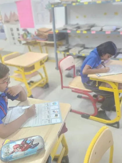 A Grade 2 student focuses intently on an activity-based learning worksheet, a method we use to make abstract concepts more concrete and understandable.