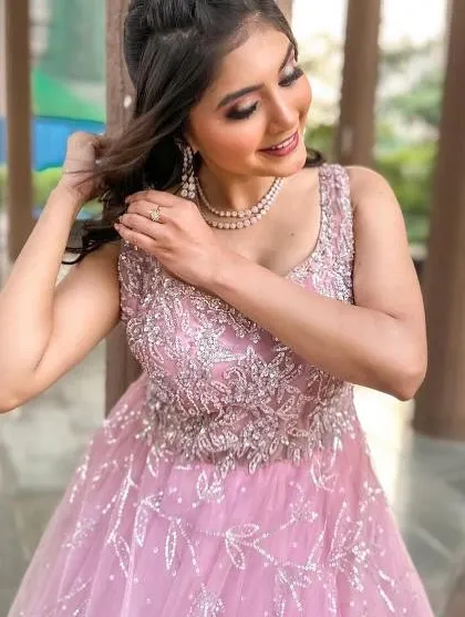 A close-up of the pink ball gown, showing the intricate silver beading on the bodice.
