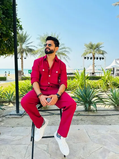 Another angle of the monochrome red outfit. It's a powerful look, especially against a natural, green backdrop.