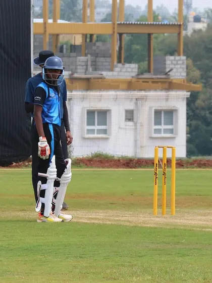 A young batsman takes his guard at the crease during a Dasara Cup match.