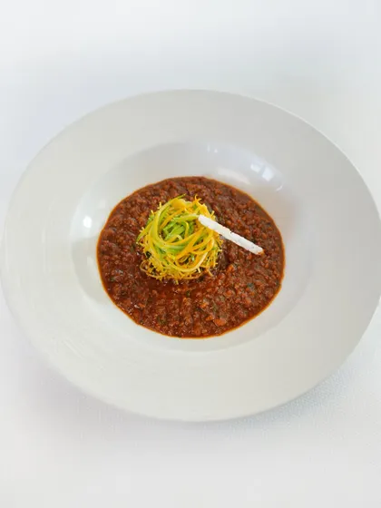 Where south meets soul. This is our Chettinad chicken keema, a richly spiced minced chicken dish served with bright lemon seviyan and crunchy sago puffs for texture.