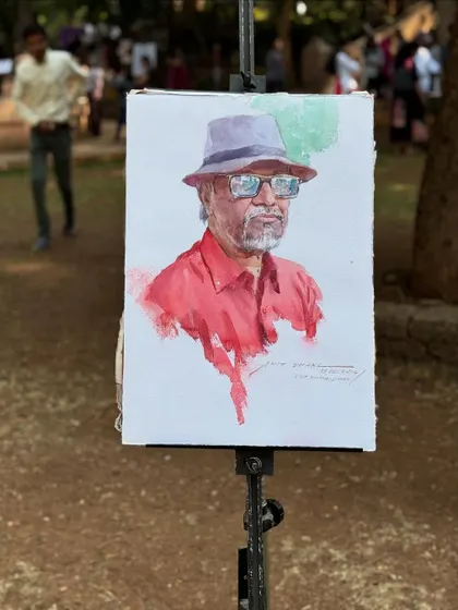 The portrait on the easel, set against the natural background of the park.