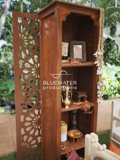 A rustic wooden shelf unit is used as a decorative element, filled with small props and artifacts.