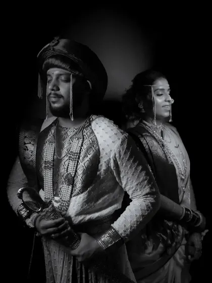 A powerful, royal-themed black and white portrait of the couple in traditional Peshwai attire.