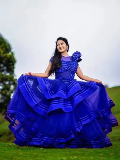 A full-length view of the stunning royal blue gown. The architectural design of the dress makes a powerful statement, perfect for a bride who wants something different for her pre-wedding shoot.