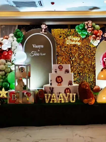 This jungle theme for Vaayu's second birthday featured a gold sequin backdrop for extra sparkle. We combined animal props, a light-up number "2", and a colourful balloon garland for a wild and glamorous celebration.