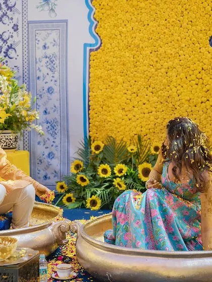 A quiet moment between the bride and groom during their colorful Haldi ceremony.