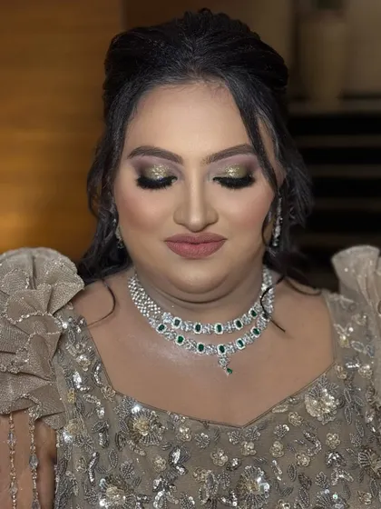 A close-up of the glittery eye makeup for this reception look. We used a mix of gold and champagne glitters to create a multi-dimensional effect that catches the light beautifully.