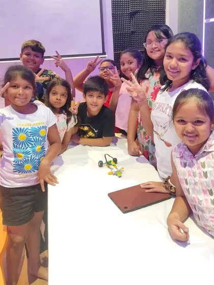 A group of smiling campers in Kolkata, proud of their creations and the new friends they've made.