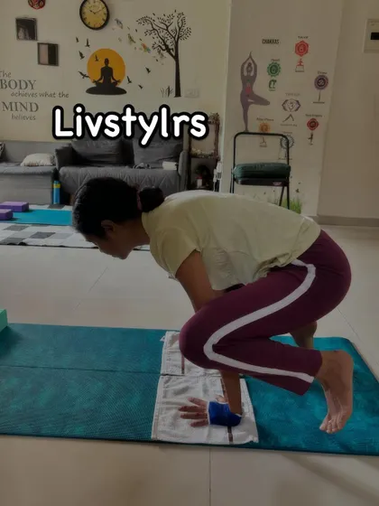 A client practices Bakasana (Crow Pose), an arm balance that builds upper body strength, core stability, and immense focus.