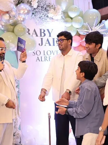 The host engaging with guests during a lively party game.