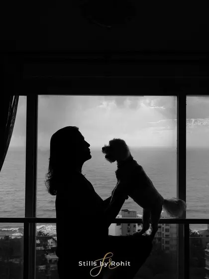 Sometimes, a simple silhouette can tell the most powerful story. This image captures the deep, unspoken love between a mother-to-be and her loyal companion against a beautiful backdrop.