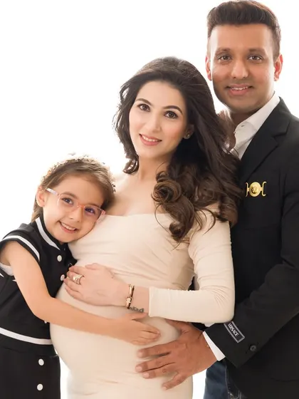A formal family portrait from a maternity session. Everyone is dressed beautifully, creating an elegant and timeless image of their growing family.