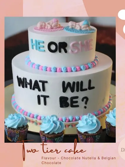 A "He or She, What Will It Be?" two-tier cake for a gender reveal party. This is a fun and exciting way to share your big news with family and friends.