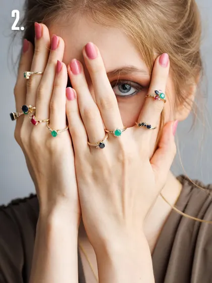 This playful shot shows how to feature multiple pieces without creating clutter. By having the model peek through her hands, we draw the eye to the variety of rings, showcasing the collection in a creative and engaging way.