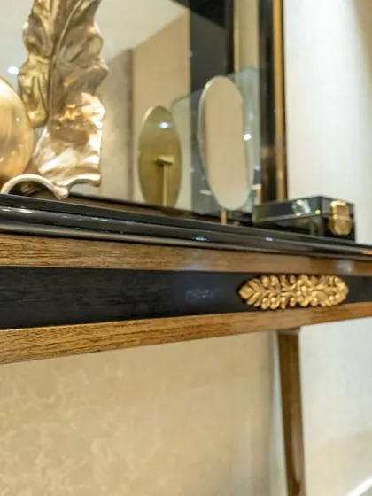 Another detail of the handcrafted console, highlighting the delicate leaf motif. This level of craftsmanship is central to our vision of luxury interior design.