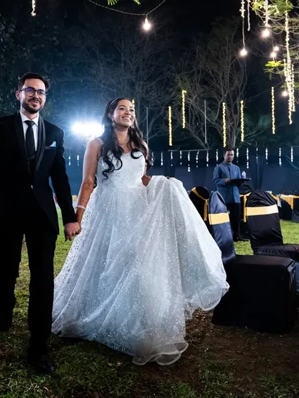 The couple makes their entrance at the cocktail party, looking elegant and happy.