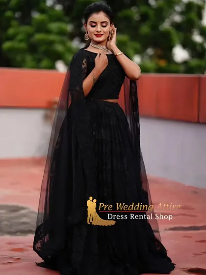 An elegant all-black lace lehenga with a cape. This is a chic and modern option for an evening pre-wedding event or photoshoot.