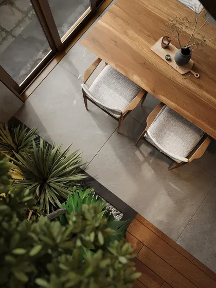 An overhead view of the dining area, emphasizing the clean lines of the furniture and the integration of the green planter box.