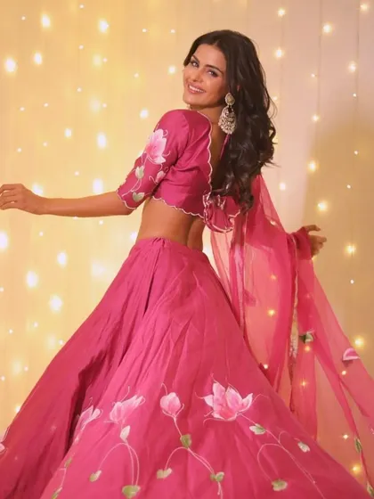 Twirling into the festival of lights. This hand-painted pink lehenga is complemented by a soft, romantic makeup look that’s perfect for Diwali celebrations.
