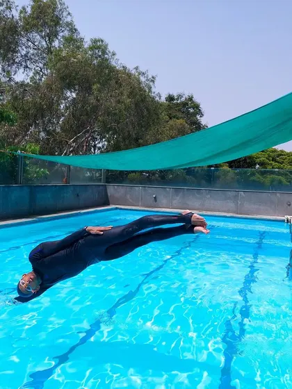 Holding the tight streamline position mid-air before entering the water. It's a technical skill that we work on constantly to improve speed and efficiency.