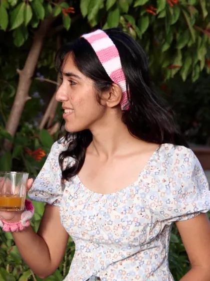 A side view of the pink striped headband. It’s comfortable to wear all day and is a simple way to add a handmade touch to your look.
