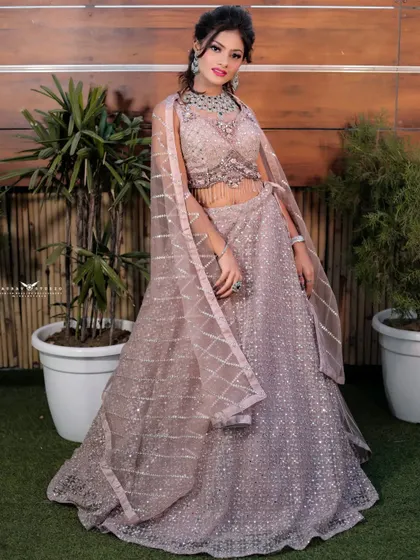 A smiling, full-length portrait of the bride. Her happy expression and the sparkling details of her outfit make this a perfect shot for capturing celebratory moments.