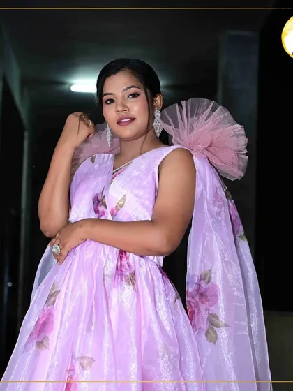 A confident and happy party look. The makeup enhances her natural smile, with bright eyes and a flawless complexion that’s ready for any celebration.