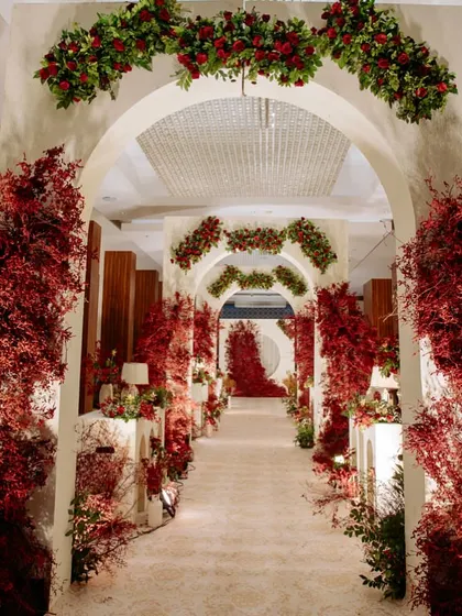 The full view of the dramatic red and white entrance aisle, a breathtaking passageway for the couple and their guests.