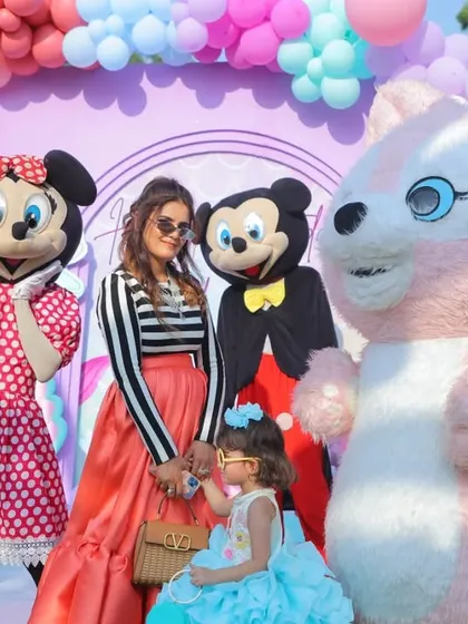 The birthday girl with her mom and her favorite characters, Mickey and Minnie Mouse. These are the magical moments that make a themed party so special.