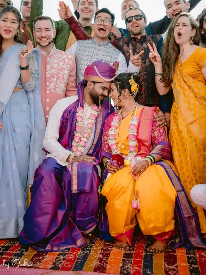 A fun group photo with the couple and their enthusiastic friends.
