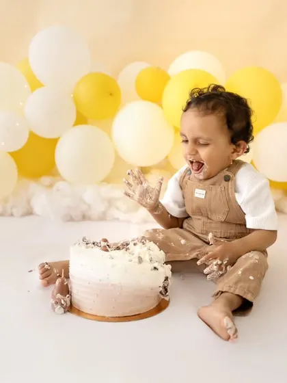 A moment of pure delight during a teddy bear themed cake smash. I love capturing the genuine expressions of babies as they explore their first birthday cake.